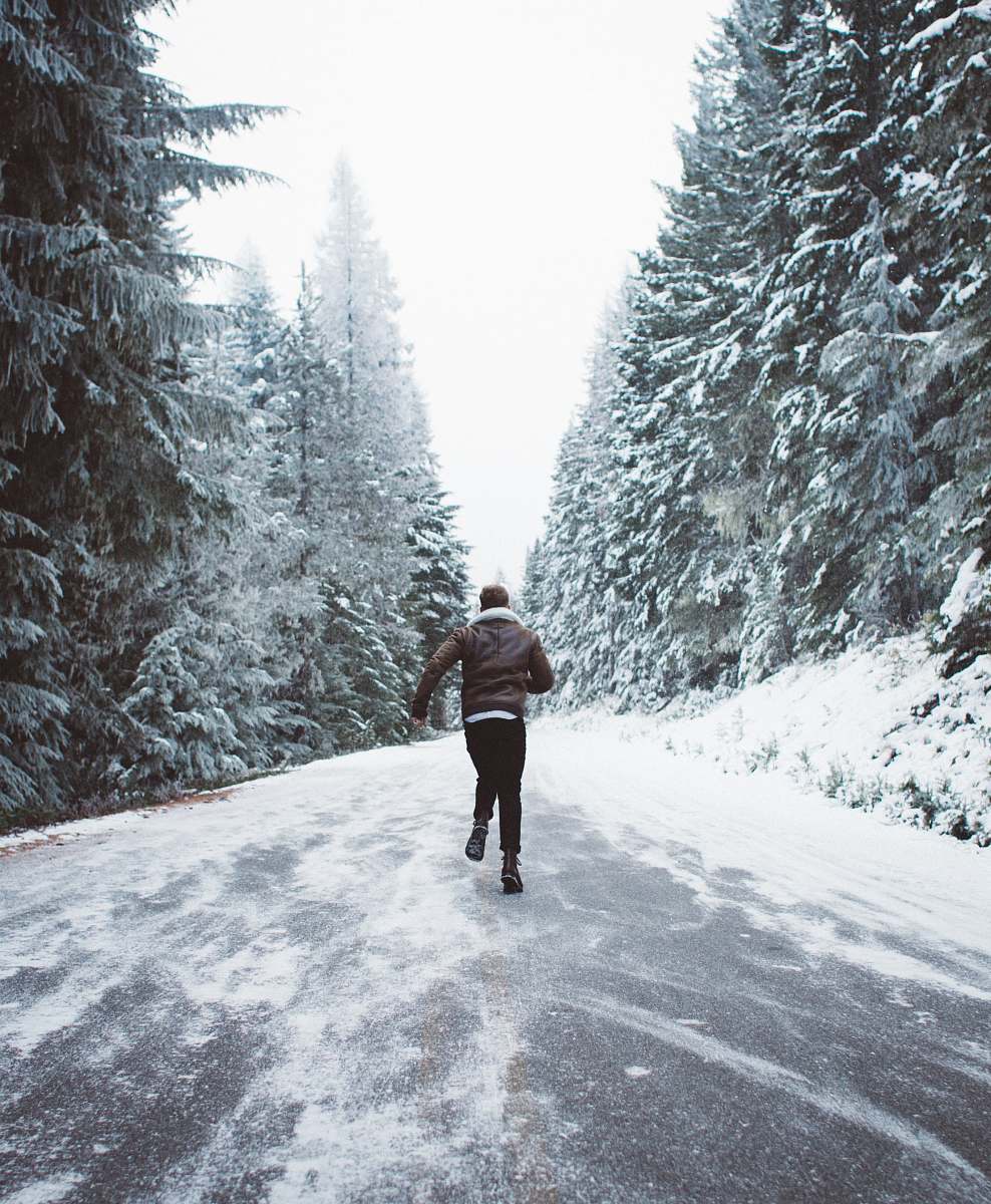sandy man wearing brown jacket runnin on frosted road united states